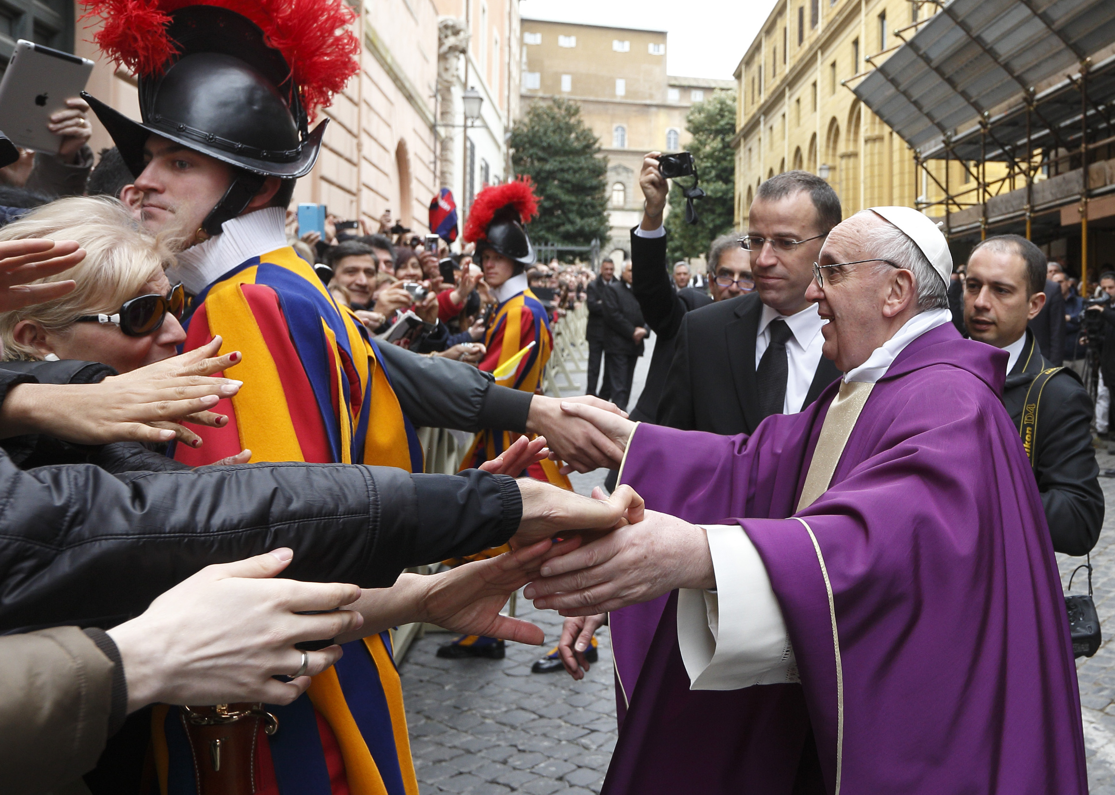 Pope Francis greets people after celebrating Mass at St. Anne's Parish within the Vatican in 2013. (CNS photo/Paul Haring)