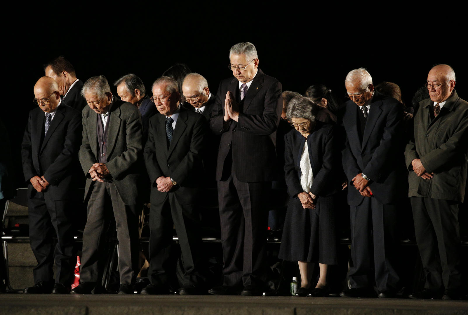 Victims of the 1945 atomic bombing observe a moment of silence during a meeting for peace led by Pope Francis at the Hiroshima Peace Memorial in Hiroshima, Japan, Nov. 24, 2019.