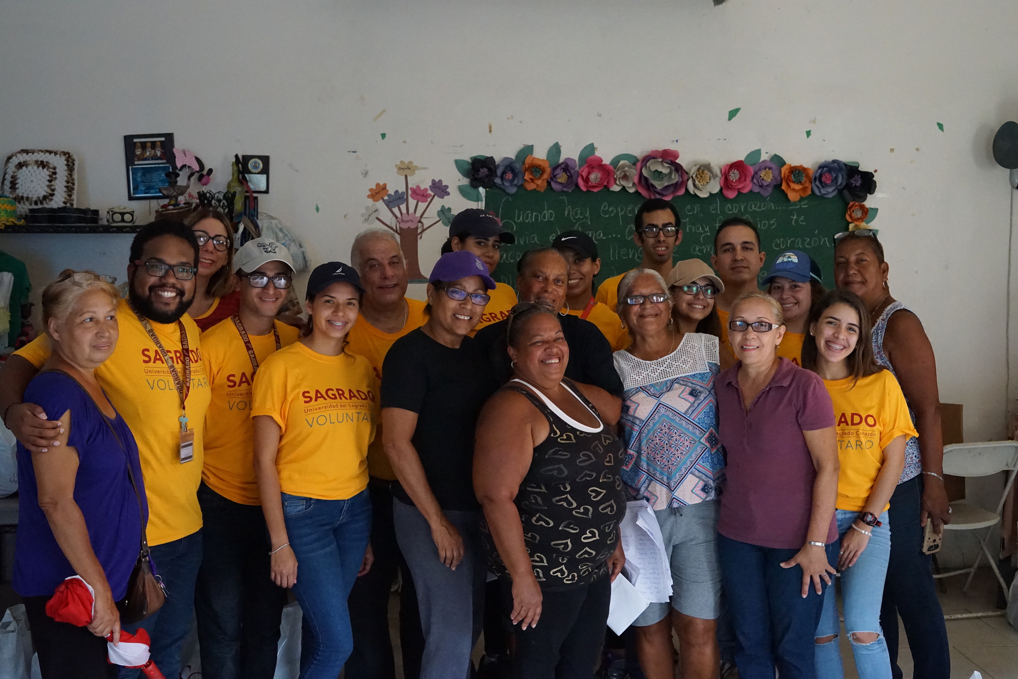 Students and community leaders pose for a photo after distributing aid in las Playitas. 