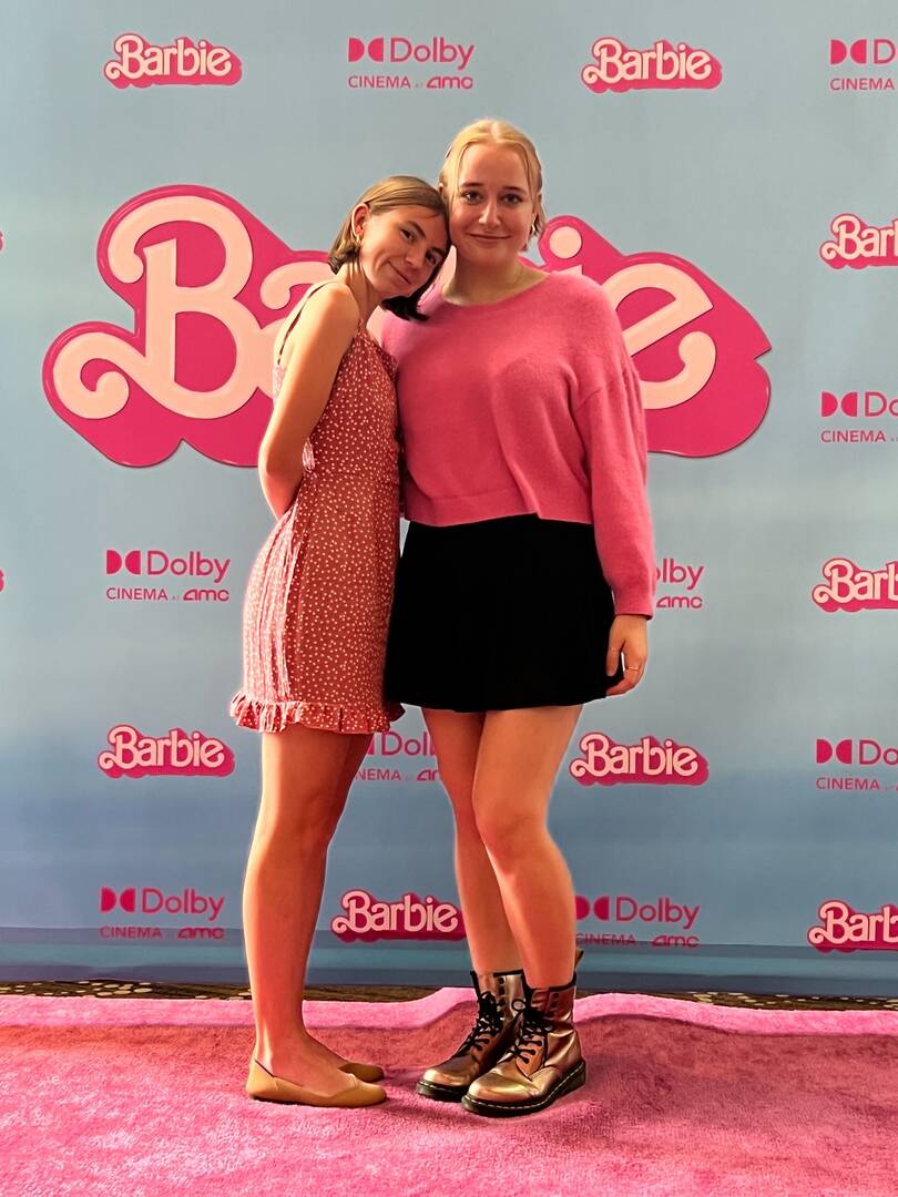 The authors of the article pictured in front of a Barbie logo