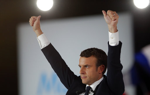 French independent centrist presidential candidate Emmanuel Macron waves to his supporters during a campaign rally in Paris, France, Monday, May 1 (AP Photo/Christophe Ena).