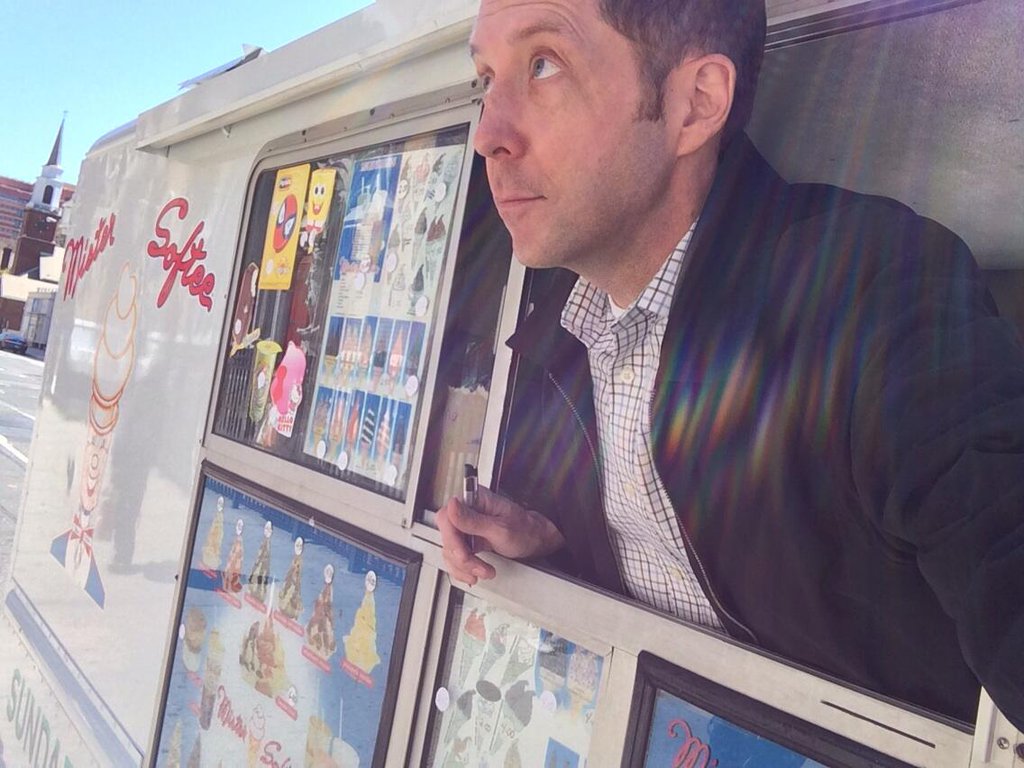 A selfie of Wilson reporting a column on turf wars between ice cream truck drivers. 