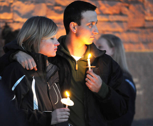 A couple attends a candlelight vigil at the Columbine Memorial in Clement Park in Littleton, Colo., April 19, 2009, the eve of the 10th anniversary of tragic shootings at Columbine High School. (CNS photo/James Baca, Denver Catholic Register) 