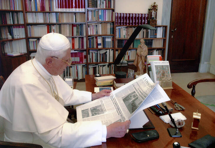 Pope Benedict XVI reading the Vatican's L'Osservatore Romano newspaper (CNS photo/L'Osservatore Romano via Catholic Press Photos)