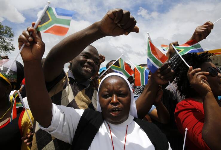 Nun marches with mourners before the arrival of body of former South African President Nelson Mandela in Mthatha.