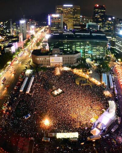 People gather at the Seoul Plaza in front of the City Hall in downtown Seoul July 24. Asian Youth Day will coincide with Pope Francis' visit to that country, where he is scheduled to beatify 124 Korean martyrs. (CNS photo/YONHAPNEWS via EPA)