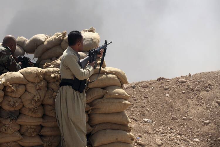 Kurdish "peshmerga" troops stand guard against Islamic State militants in Iraq. (CNS photo/Reuters) 