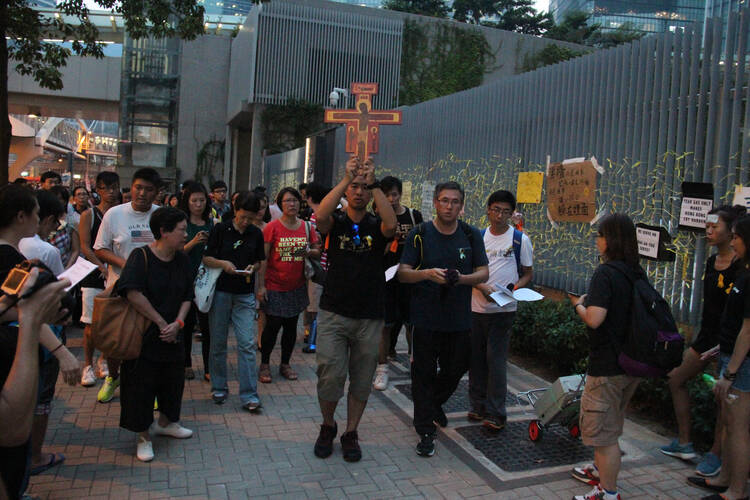 About 100 Catholic youths pray for democracy outside Hong Kong's government headquarters building Sept. 30. (CNS photo/Francis Wong) 
