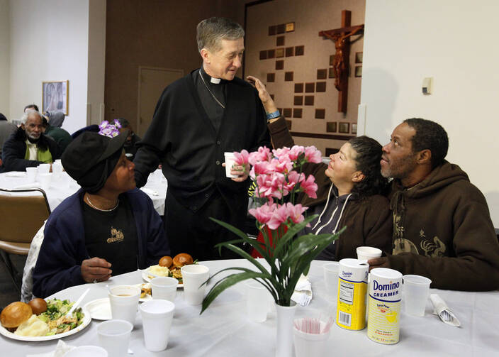New Chicago archbishop greets guests during Thanksgiving dinner for homeless and hungry.