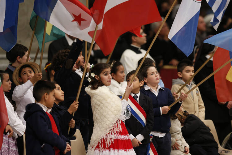 Children hold flags of American nations during Mass marking feast of Our Lady of Guadalupe in St. Peter's Basilica.