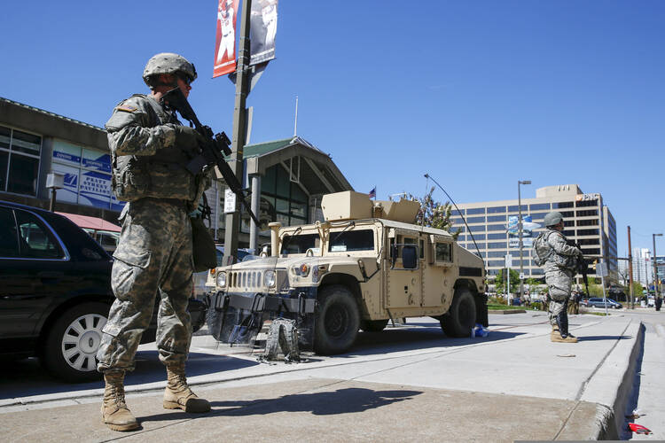 Members of the Maryland National Guard patrol the harbor section of Baltimore April 28, following riots in that city over the death of Freddie Gray while in police custody. (CNS photo/Shannon Stapleton, Reuters)