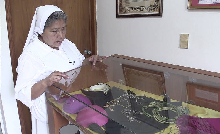 Carmelite Sister Maria Julia Garcia shows some of Archbishop Oscar Romero's relics at a museum in San Salvador. 