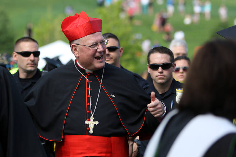 Cardinal Timothy M. Dolan of New York arrives for the 65th commencement at Jesuit-run Le Moyne College in Syracuse, N.Y., May 17. Cardinal Dolan delivered the ceremony's commencement address and received an honorary degree. (CNS photo/Gregory A. Shemitz) 