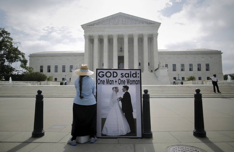 An opponent of same-sex marriage protests outside the U.S. Supreme Court in Washington June 18. (CNS photo/Carlos Barria, Reuters) 