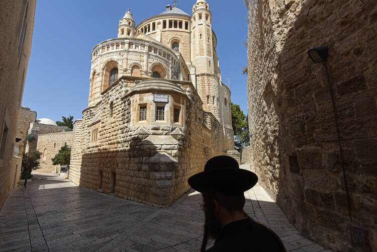 An Ultra-Orthodox Jew walks past the Dormition Abbey on Mt. Zion in Jerusalem in July. (CNS photo/Debbie Hill) 