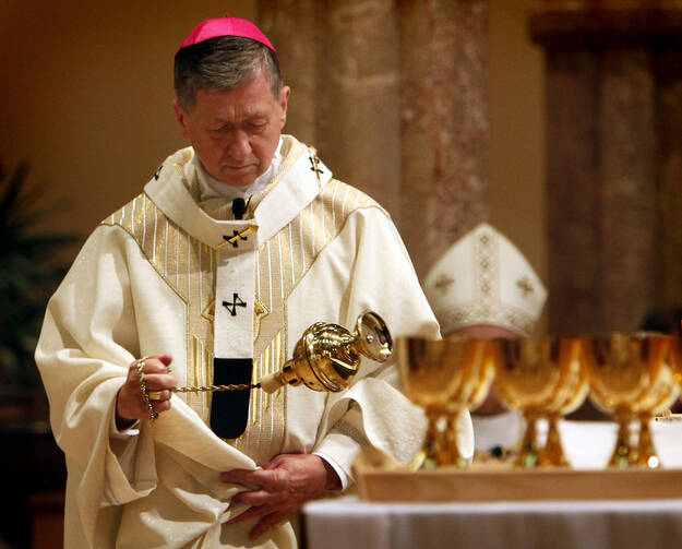 Archbishop Blase J. Cupich of Chicago swings a censer over the altar during an Aug. 23 Mass at Holy Name Cathedral in Chicago where he received the pallium. (CNS photo/Karen Callaway, Catholic New World)