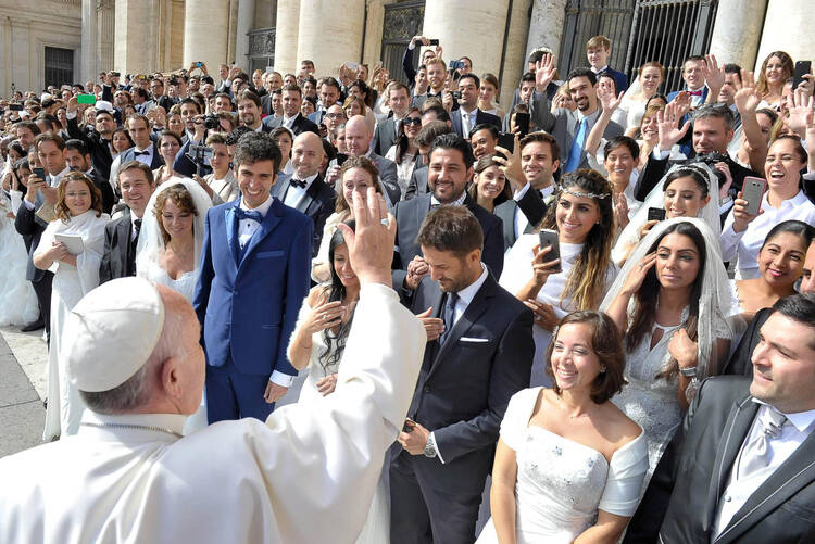Pope Francis greets young married couples in St. Peter's Square, Sept. 30. (CNS photo/L'Osservatore Romano) 