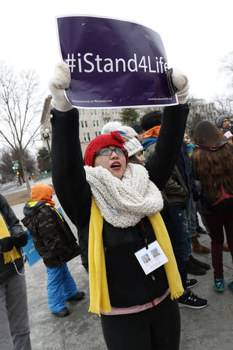 A pro-life advocate prays in near the Supreme Court building during the March for Life in Washington Jan. 22, the 43rd anniversary of the Supreme Court's Roe v. Wade decision legalizing abortion in the U.S. (CNS photo/Gregory A. Shemitz) 