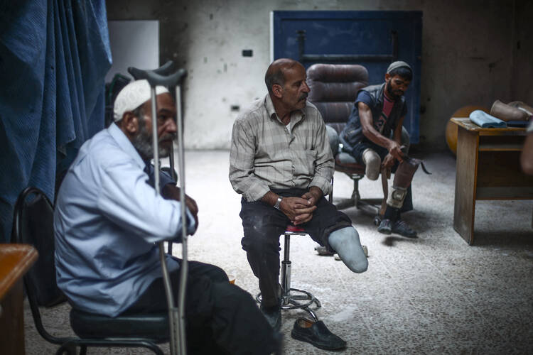 Syrian men who lost limbs during the civil war get prosthetic legs in Hamorya, Syria, in this Oct. 22, 2015, file photo. (CNS photo/Mohammed Badra, EPA)