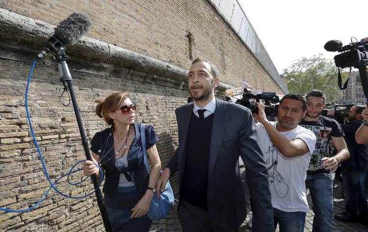 Journalist Emiliano Fittipaldi walks to his trial April 6 at the Vatican. (CNS photo/Remo Casilli, Reuters)