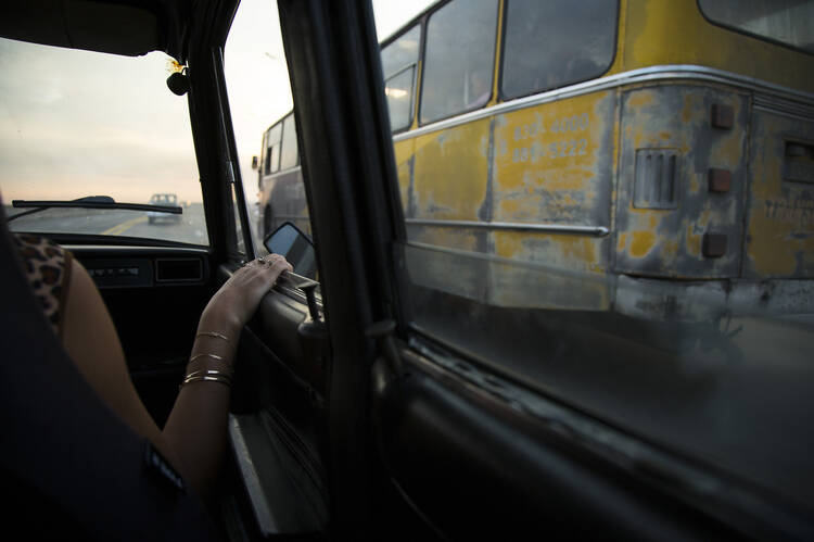 A woman rides in a taxi in Havana on Sept. 21, 2015. (CNS photo/Tyler Orsburn)