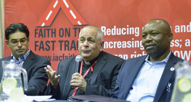 Msgr. Robert J. Vitillo, special adviser on health and HIV/AIDS for Caritas Internationalis, opens a panel discussion during a July 16 gathering before the International AIDS Conference in Durban, South Africa. (CNS photo/Paul Jeffrey) 