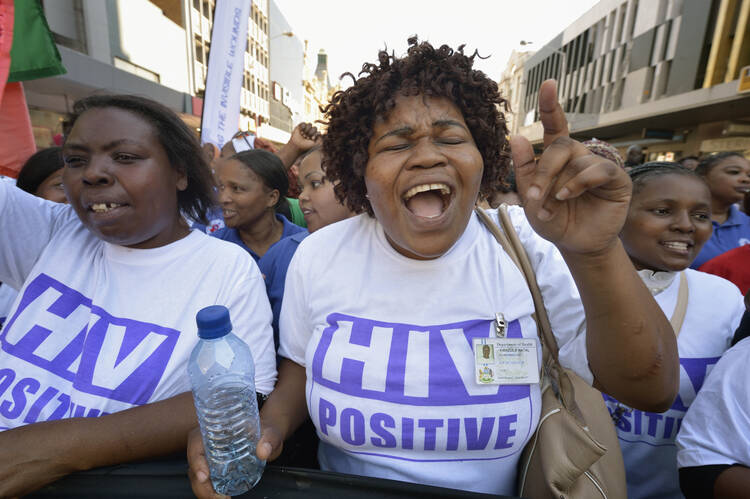 Demonstrators march through the streets of Durban, South Africa, on July 18, demanding better funding for HIV and AIDS treatment around the world. (CNS photo/Paul Jeffrey)