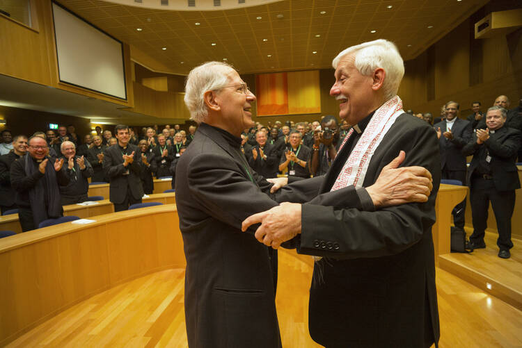 Jesuit Father Arturo Sosa, right, greets the previous superior general, Jesuit Father Adolfo Nicolas, after his election in Rome Oct. 14, 2016. (CNS photo/Don Doll, S.J.)