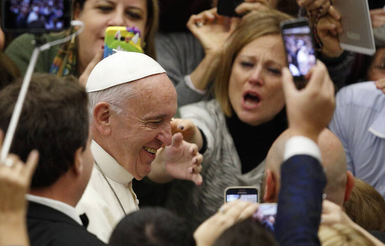 Pope Francis arrives to lead his general audience in Paul VI hall at the Vatican Nov. 23. (CNS photo/Paul Haring)