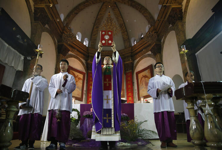 A priest celebrates Mass Dec. 4 in the Cathedral of the Immaculate Conception in Beijing. (CNS photo/How Hwee Young, EPA)