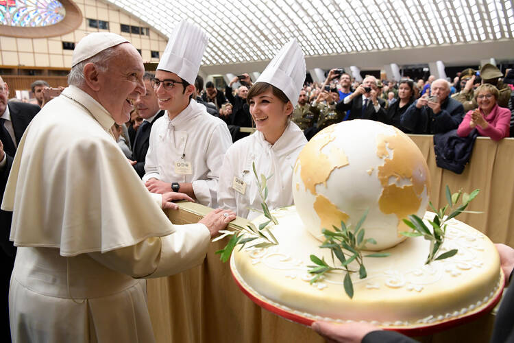 Pope Francis accepts a birthday cake from chefs during his general audience in Paul VI hall at the Vatican Dec. 14. The pope will turn 80 Dec. 17. (CNS photo/L'Osservatore Romano, handout)