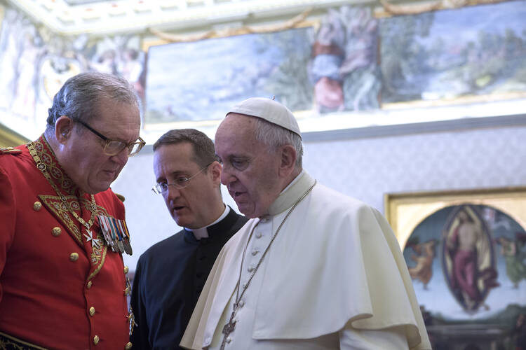 Pope Francis talks with Fra Matthew Festing, grand master of the Sovereign Military Order of Malta, during a private audience with members of the order at the Vatican in this June 23, 2016, file photo. (CNS photo/Maria Grazia Picciarella, pool)
