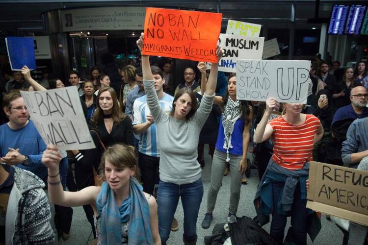 People gather for a protest at the Arrivals Hall of San Francisco's International Airport after people coming in from Muslim-majority countries were held on Jan. 28 by border control as a result of the new executive memorandum by U.S. President Donald Trump. (CNS photo/Peter Dasilva, EPA) 