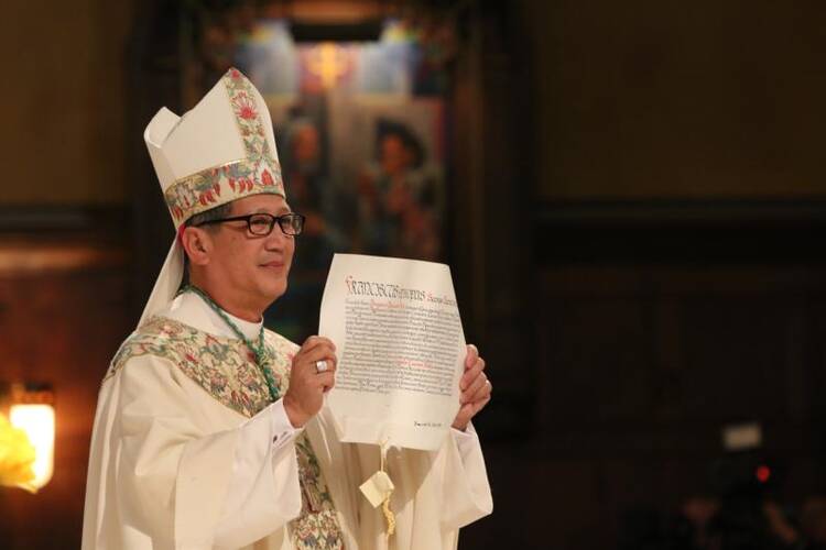 Bishop Oscar A. Solis presents the apostolic mandate naming him Salt Lake City's bishop during his installation Mass on March 7 at the Cathedral of the Madeleine in Salt Lake City. (CNS photo/J.D. Long-Garcia, The Tidings)