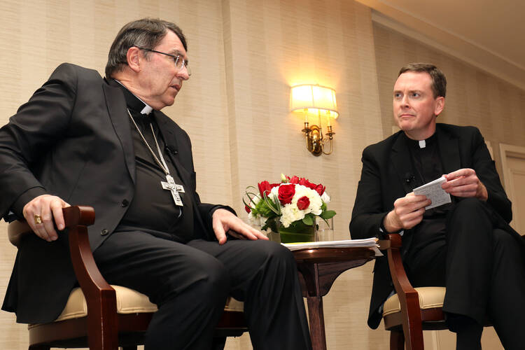 Archbishop Christophe Pierre, apostolic nuncio to the United States, responds to a question from Jesuit Father Matt Malone, president and editor-in-chief of America Media, during a discussion March 15 in New York City on the first four years of Pope Francis' papacy. (CNS photo/Gregory A. Shemitz)