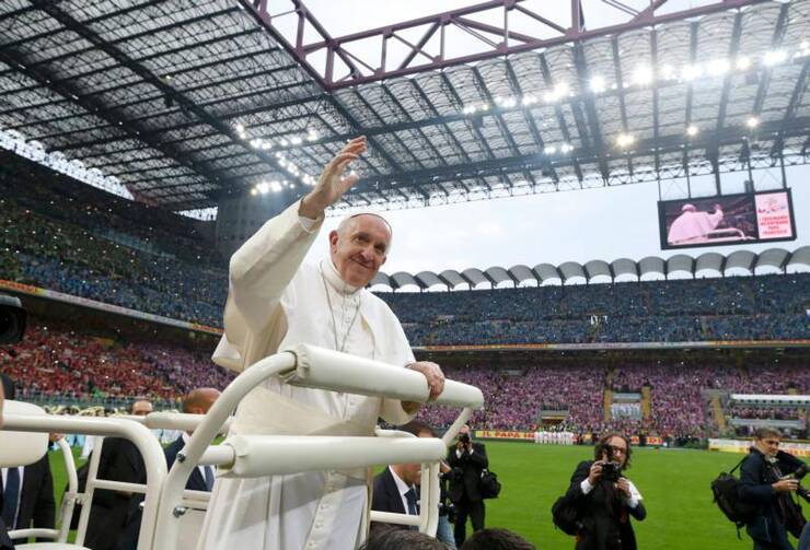 Pope Francis greets the crowd during an encounter with confirmation candidates at San Siro Stadium in Milan on March 25. (CNS photo/Stefano Rellandini, Reuters) 