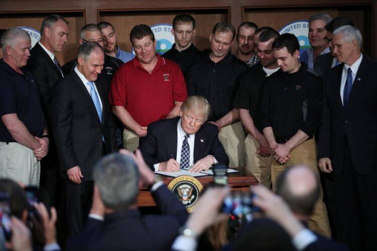 U.S. President Donald Trump signs an executive order titled "Energy Independence" during a on March 28 event at the Environmental Protection Agency headquarters in Washington. (CNS photo/Carlos Barria, Reuters)