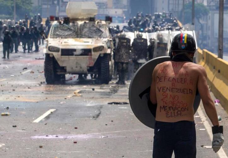 A protester faces the National Guard during clashes on May 10 in Caracas, Venezuela.  (CNS photo/Miguel Guitierrez, EPA) 
