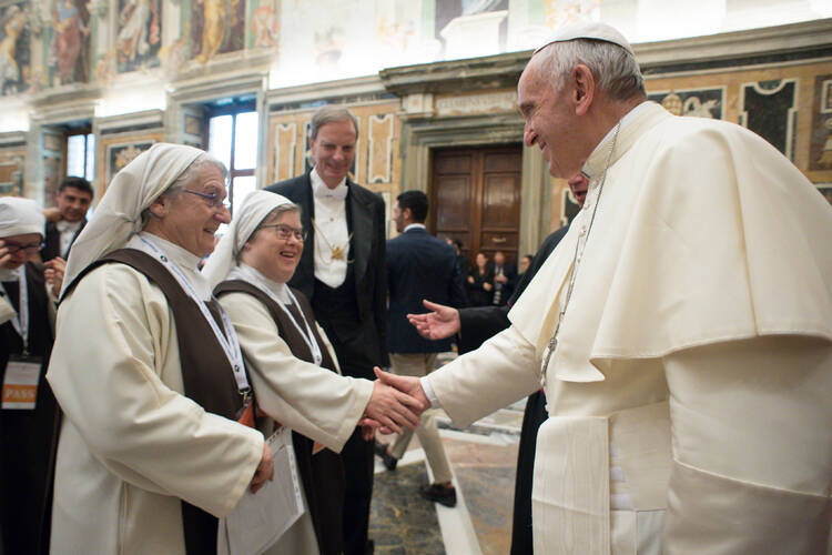 Pope Francis greets a French nun with Down Syndrome during an audience at the Vatican on Oct. 21, 2017. (CNS photo/L'Osservatore Romano)