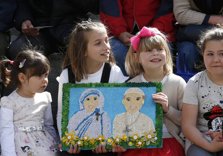 Children hold a gift showing St. Teresa of Kolkata and Pope Francis before the pope's visit to the Mother Teresa Memorial in Skopje, North Macedonia, May 7, 2019. (CNS photo/Paul Haring)