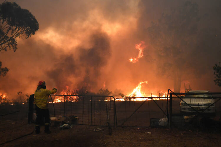 Rural Fire Service crews engage in property protection during wildfires along the Old Hume Highway near the town of Tahmoor, Australia, outside Sydney, Dec. 19, 2019. Wildfires have been burning since August and have destroyed an area comparable to the combined region of the Netherlands and Belgium. (CNS photo/Dean Lewins, AAP via Reuters)