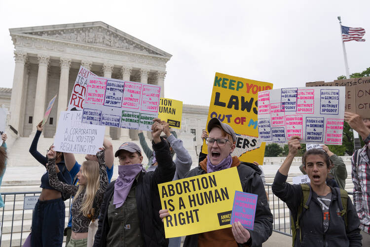 Demonstrators protest outside of the U.S. Supreme Court on May 3, 2022 in Washington. (AP Photo/Jose Luis Magana)