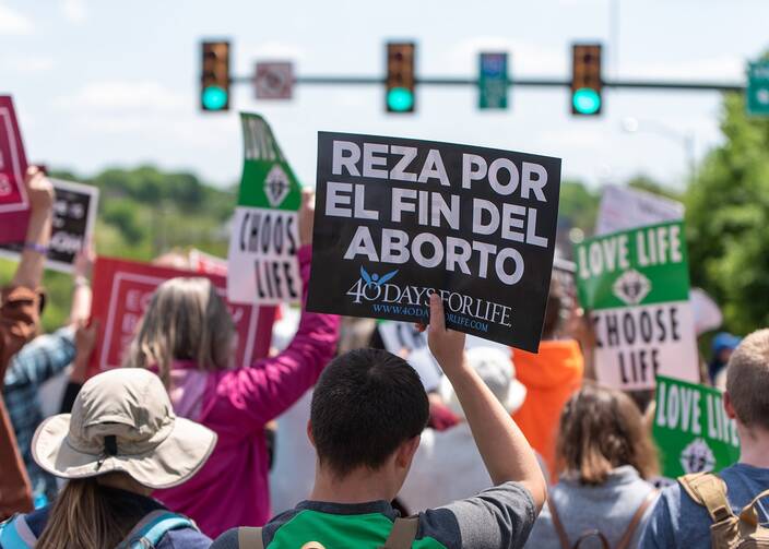 A participant in the fourth annual Virginia March for Life in Richmond, Va., on April 27, 2022, carries a sign in Spanish reading "Pray for an end to abortion." (CNS photo/Michael Mickle, The Catholic Virginian)