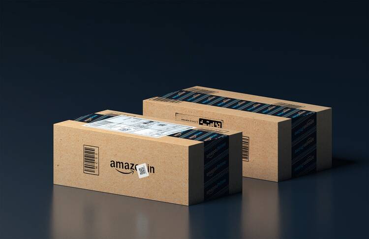 Two amazon packages against a black gradient background