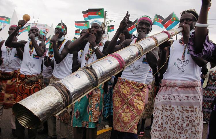 Civilians celebrate the signing of peace agreement between the Sudan's transitional government and Sudanese revolutionary movements to end decades-old conflict, in Juba, South Sudan, in this Oct. 3, 2020, file photo. (CNS photo/Samir Bol, Reuters)