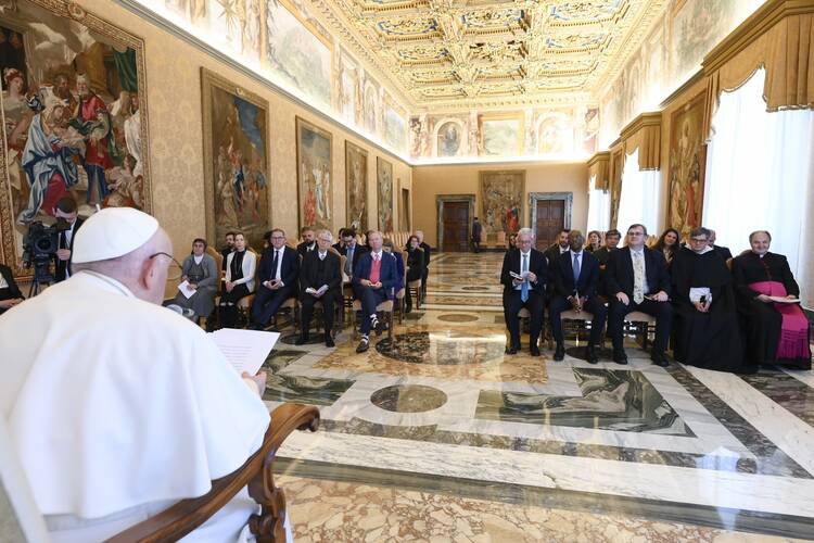 the pope is seated facing away from the camera in front, facing a crowd of people in business clothes who represent artificial intelligence and tech industry leaders