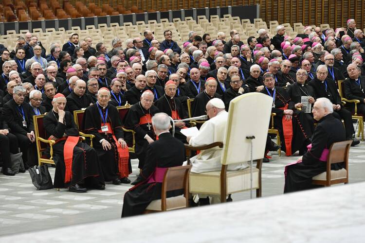 pope francis sits in his white chair in front of a group of italian bishops and leaders