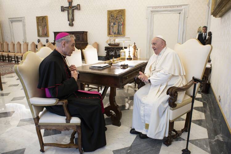 pope francis sits and talks to archbishop georg gaenswein the former secretary to benedict xvi