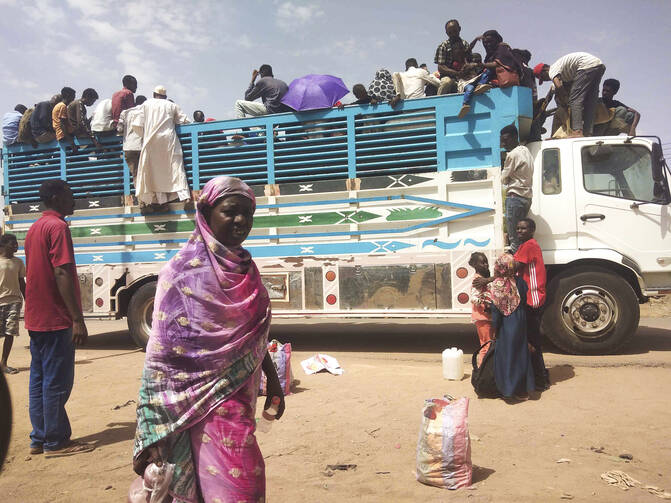 People board a truck as they leave Khartoum, Sudan, on June 19, 2023. Clashes resumed between Sudan's military and a powerful paramilitary force after a three-day cease-fire expired Wednesday morning, June 21, 2023, a protest group and residents reported. (AP Photo, File)