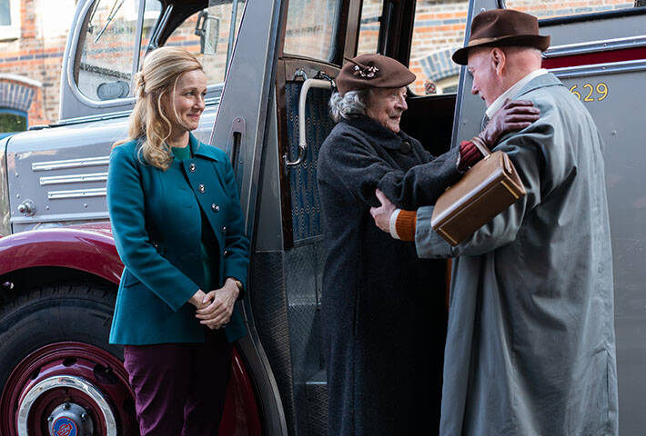 Laura Linney and Maggie Smith prepare to board a bus in a scene from the film ‘The Miracle Club’ 
